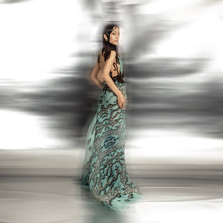 full body side view of Women's reef printed asymmetrical couture gown with open back and artistic drape – textured statement piece for cocktail or red carpet