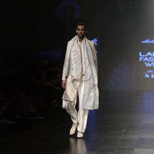 Short length single button closure sherwani with concealed placket. Cotton khadi sherwani is meticulously printed in abstract bias stripes and styled with draped wide pants, shirt and forest print textured stole. A look that is perfect for the modern day groom who slay and know how to carry the attitude.  abhisheksharma , abhishekstudio