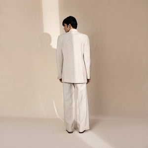 Men's ivory Bandhgala suit with tonal chevron texture and structured longline back – minimal Indian festive ensemble