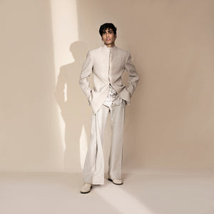 full front view of Men's ivory chevron Bandhgala with layered leaf-textured shirt and wide-leg pants – artistic Indian fusion suit