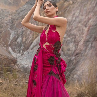 close-up of Women's fuchsia sculpted gown with cutout bodice and black floral applique – avant-garde red carpet couture