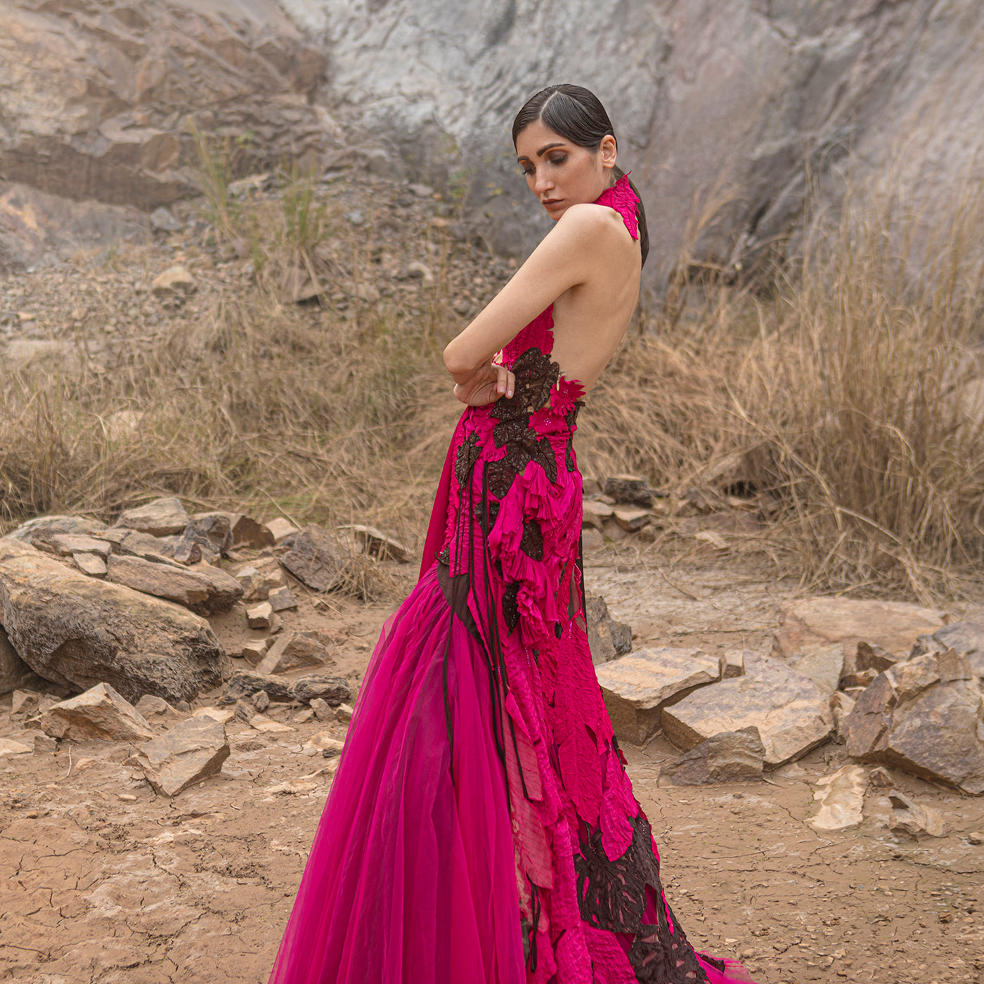 profile shot of Women's hot pink sculpted gown with black applique and sheer open back – bold red carpet couture look