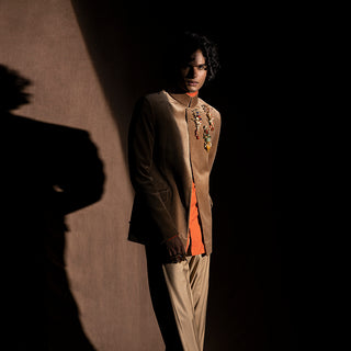 profile shot of Men's brown velvet Bandhgala with jewel-encrusted detailing and mandarin collar – tailored festive menswear with contrast inner shirt, reception or occasion style